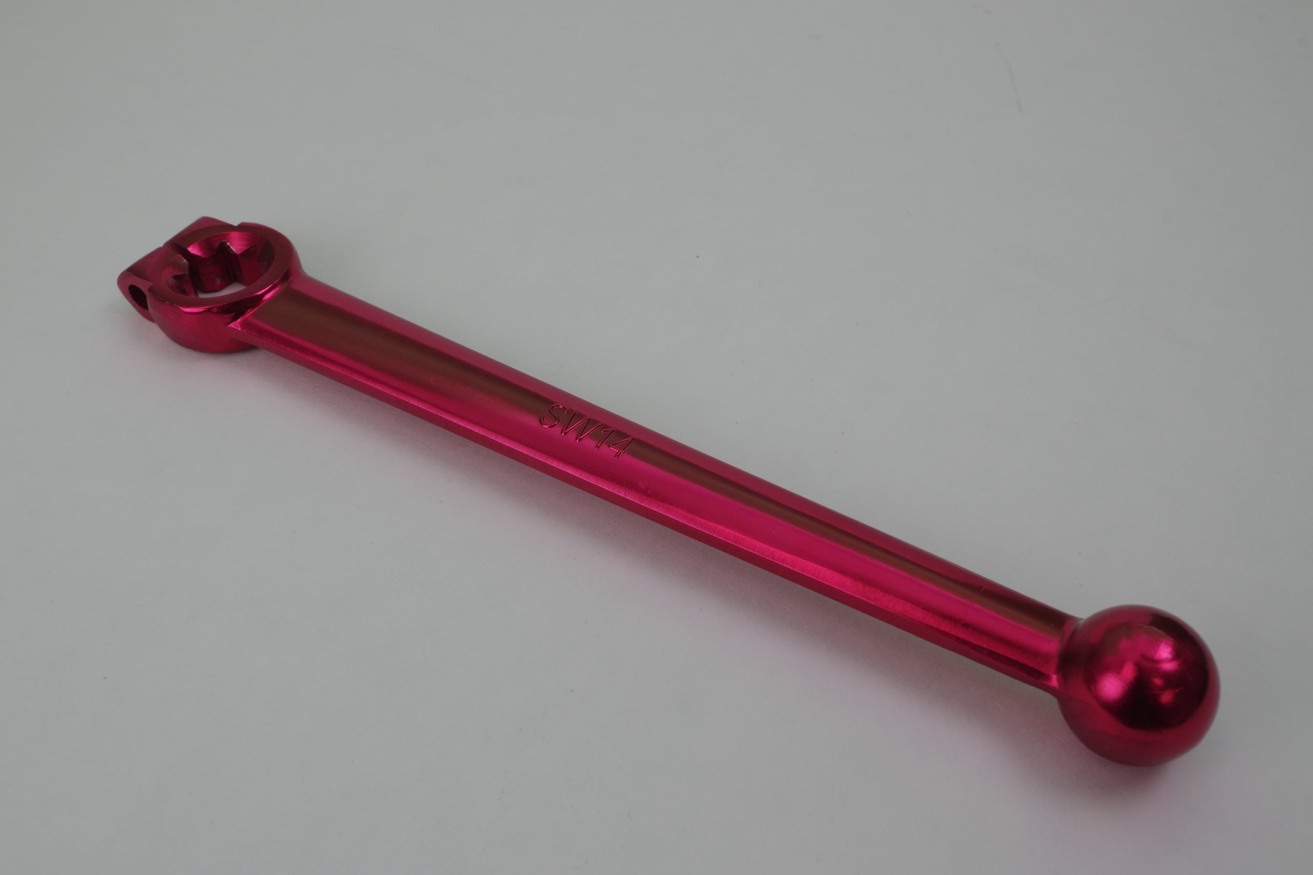 Red metal tool on a gray background