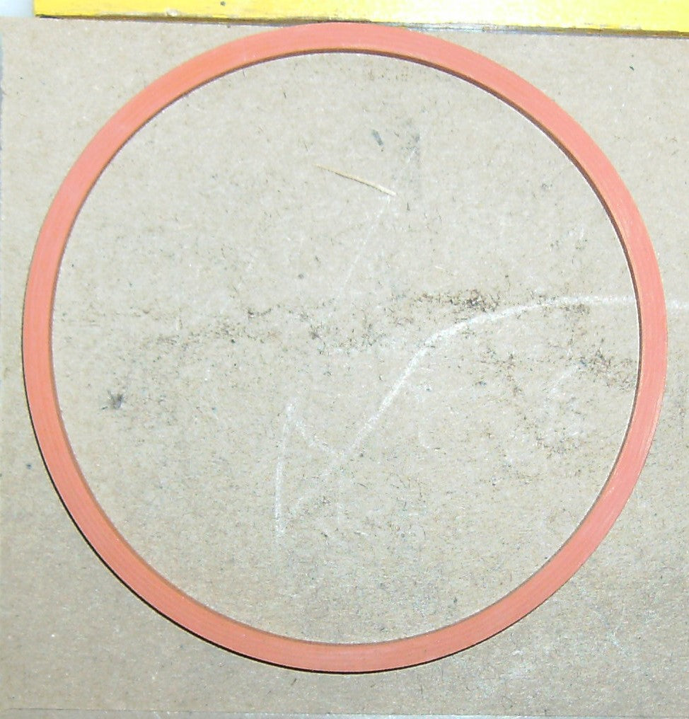 Red circular object on a beige background