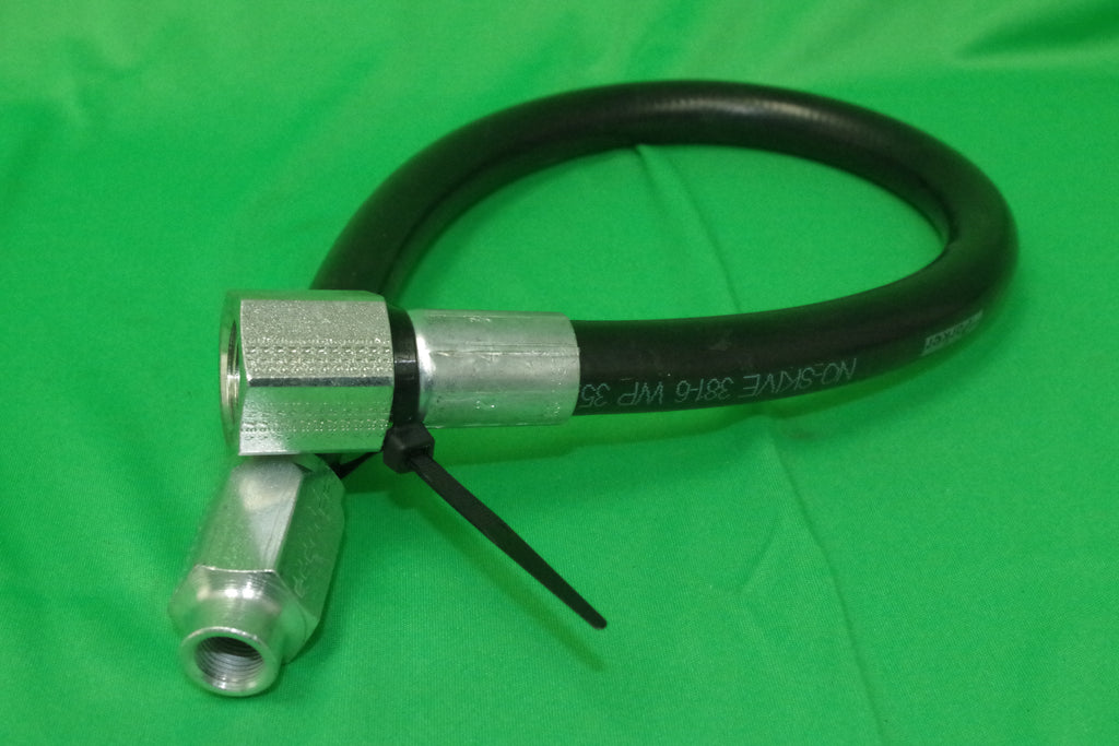 Hose with metal fitting on a green background