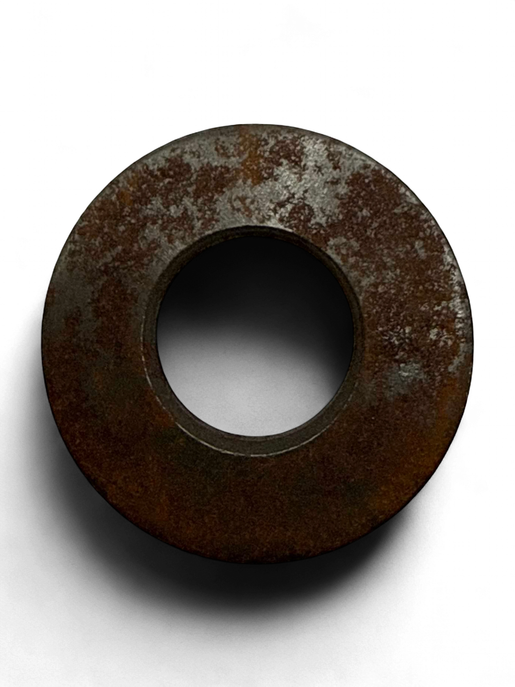 Range Supply FMC Bean L-0614 pump power assembly metal washer with visible surface oxidation on a black background