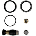 Set of mechanical parts including black rubber rings and brass components on a white background