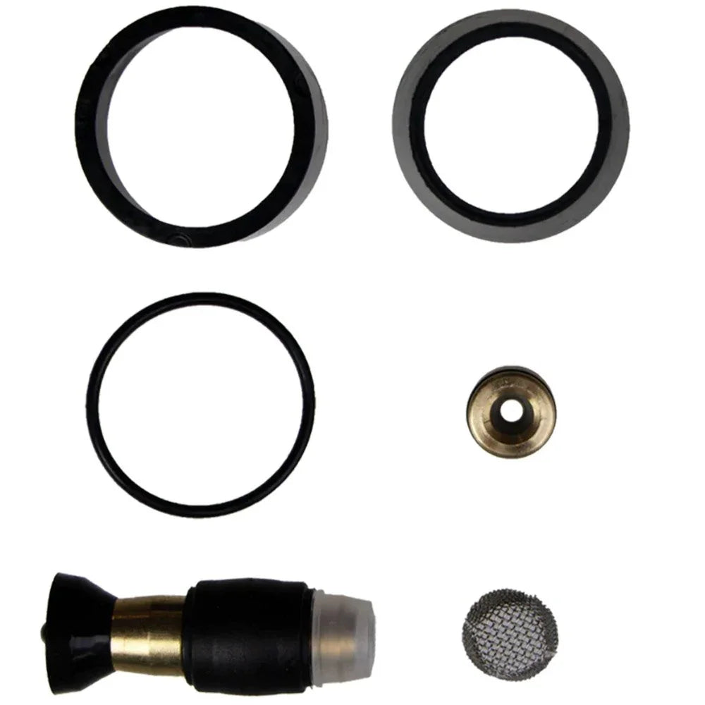 Set of mechanical parts including black rubber rings and brass components on a white background