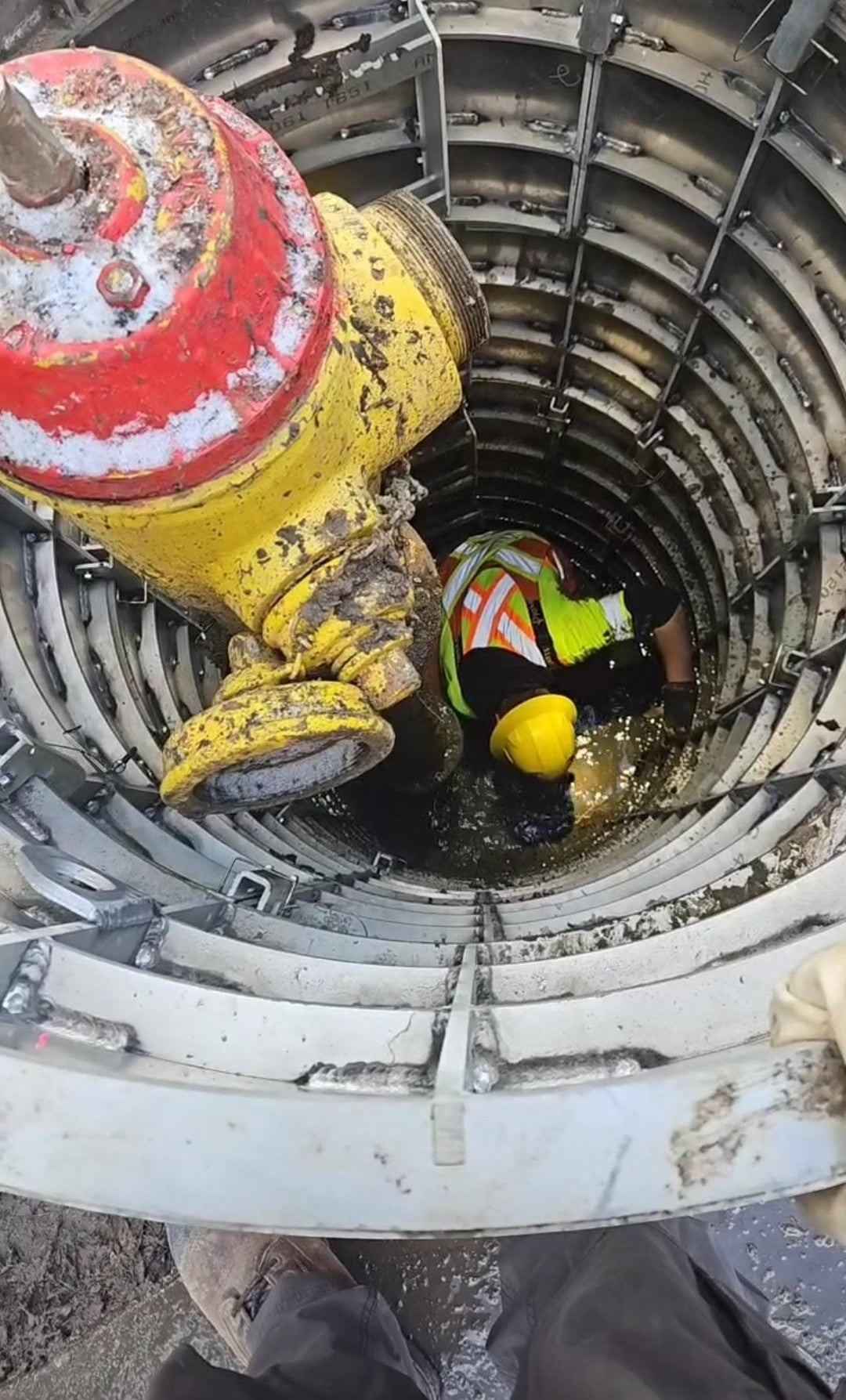 Sewershop EasyDig modular circular trench cage protecting a worker performing utility repairs on a fire hydrant