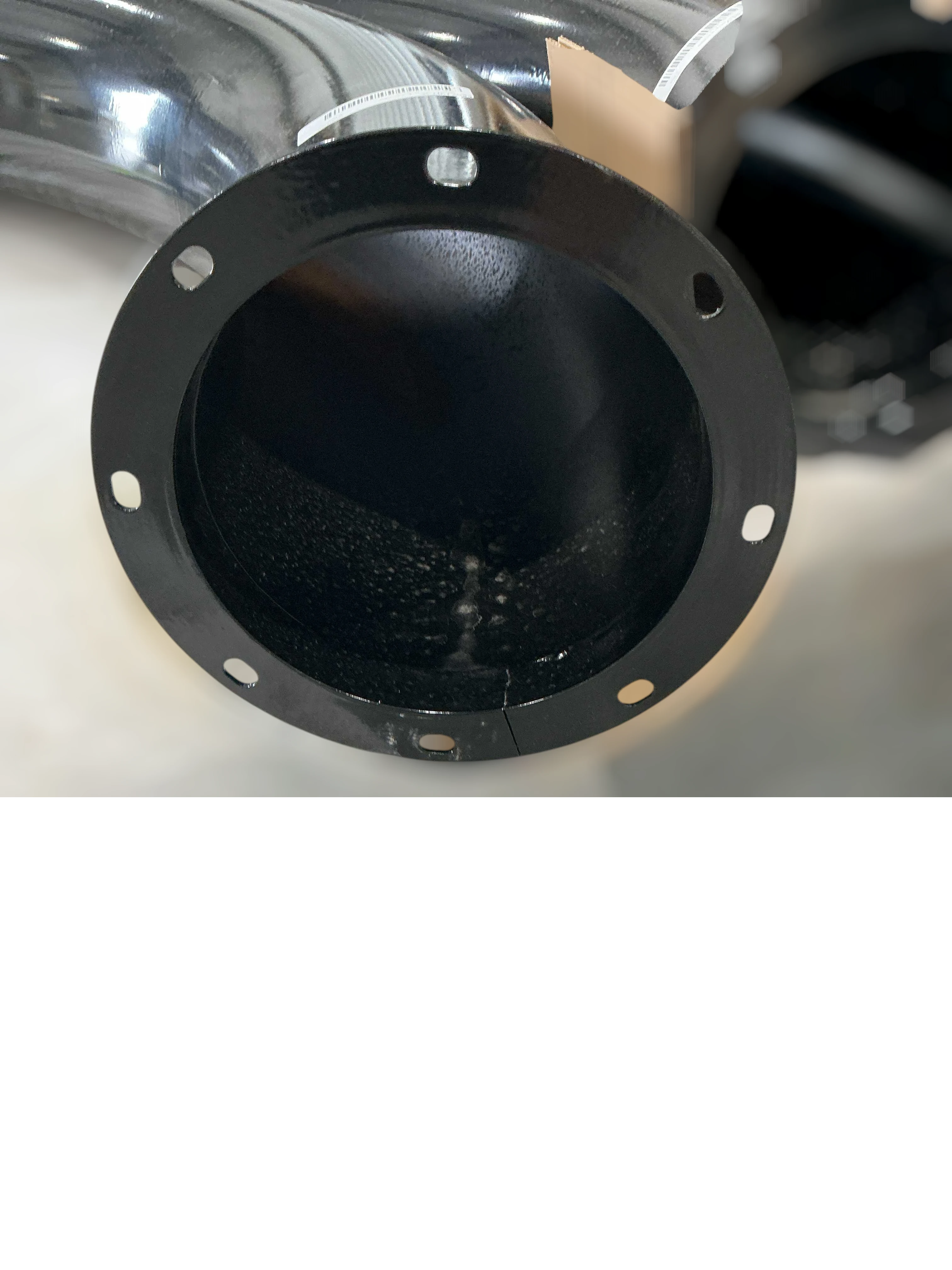 Sewershop 70° flanged boom elbow made from black Schedule 80 pipe for vacuum truck systems.